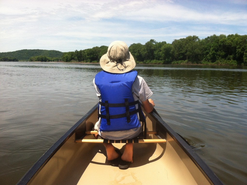 Owen in front of canoe