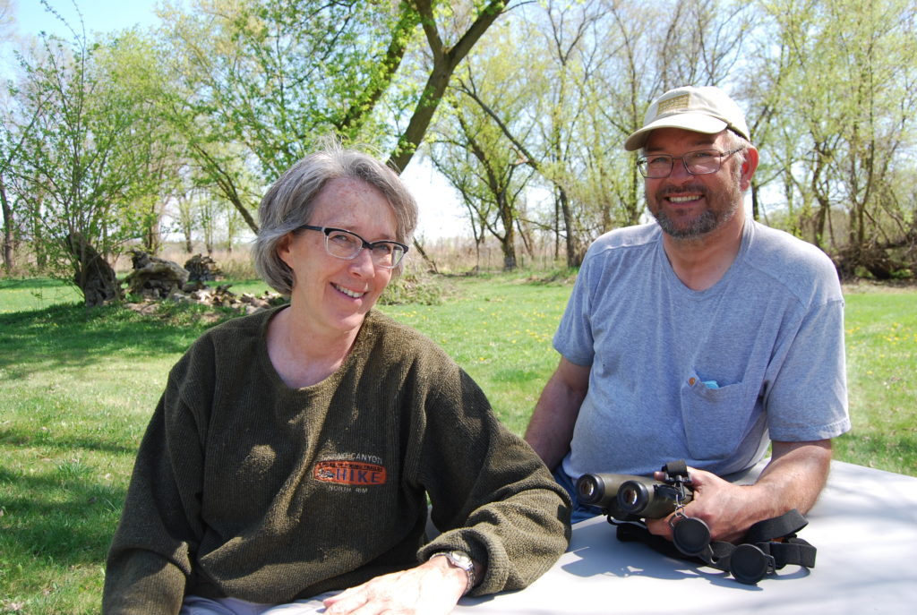 Jeff and Lori sitting outside of their home.